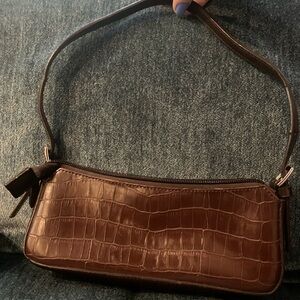 SASTI bag. Small & sweet! 9 inches by 4 inches. Brown leather. Adjustable strap